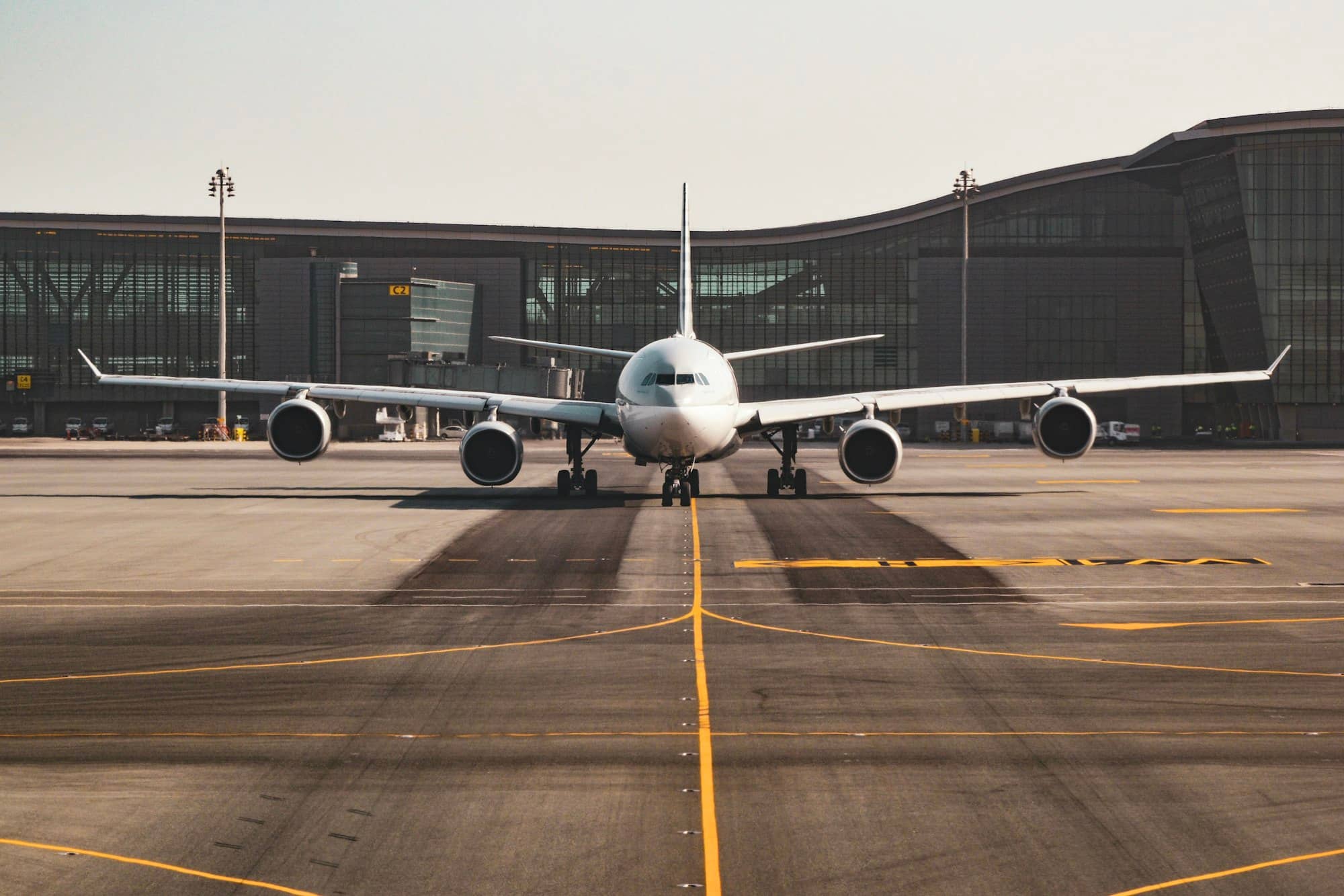 Wide-body aircraft on the apron in front of a modern airport terminal